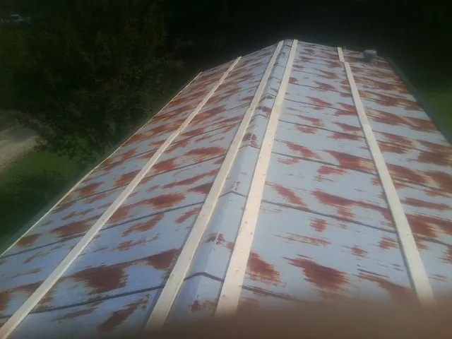 Rusted metal roof panels with new wood purlins before replacement — Storm Damage Roof Repair in Saltillo by Roofing Brothers